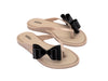 Melissa Flip Flop in beige with a cute flat bow design, stylish and comfortable slip-on footwear for women.