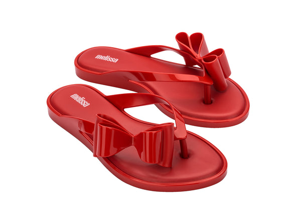 Melissa Flip Flop in red with a cute flat bow design, stylish and comfortable slip-on footwear for women.