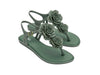 Melissa Solar Springtime flat flip-flops in green, featuring a delicate flower design, perfect for casual and outdoor wear.