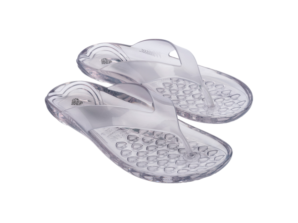 Melissa The Real Jelly Clear Flip Flop Slippers – Transparent and water-resistant jelly flip-flops made from signature fruit-scented PVC, offering comfort and style for everyday wear.