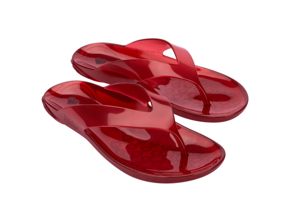 Melissa The Real Jelly Red Flip Flop Slippers – Stylish and water-resistant jelly slippers made from signature fruit-scented PVC, offering comfort and a bold red design for everyday wear.